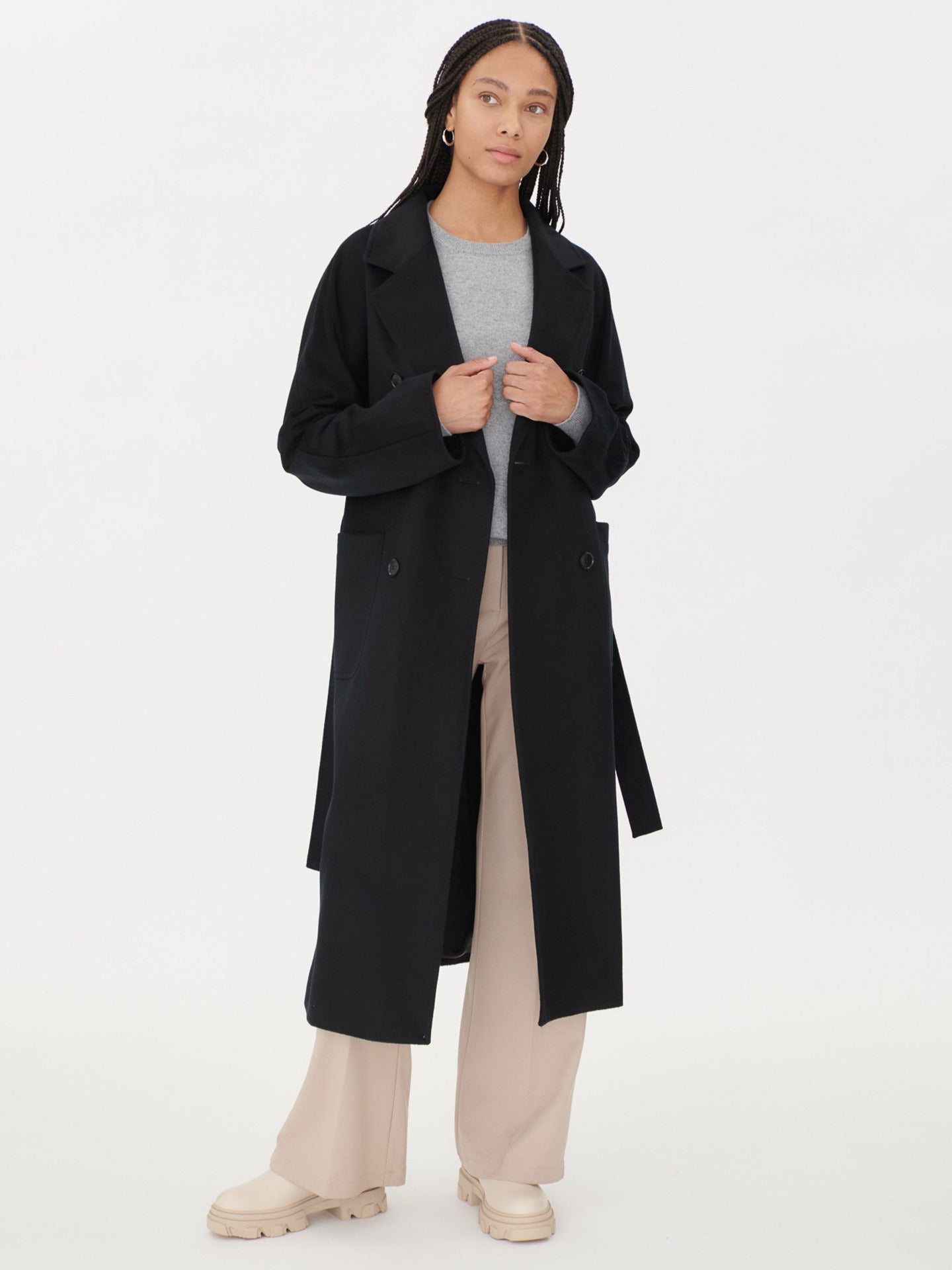 A model wearing a warm cashmere coat, styled with a belted waist for an elegant and cozy look.