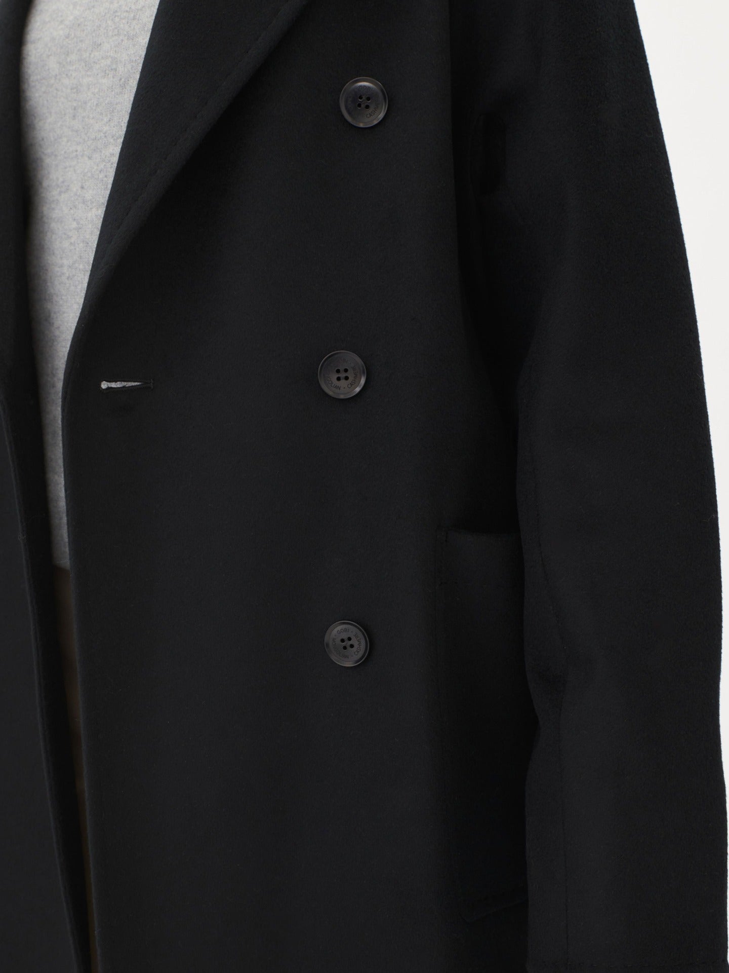 A model wearing a warm cashmere coat, styled with a belted waist for an elegant and cozy look.