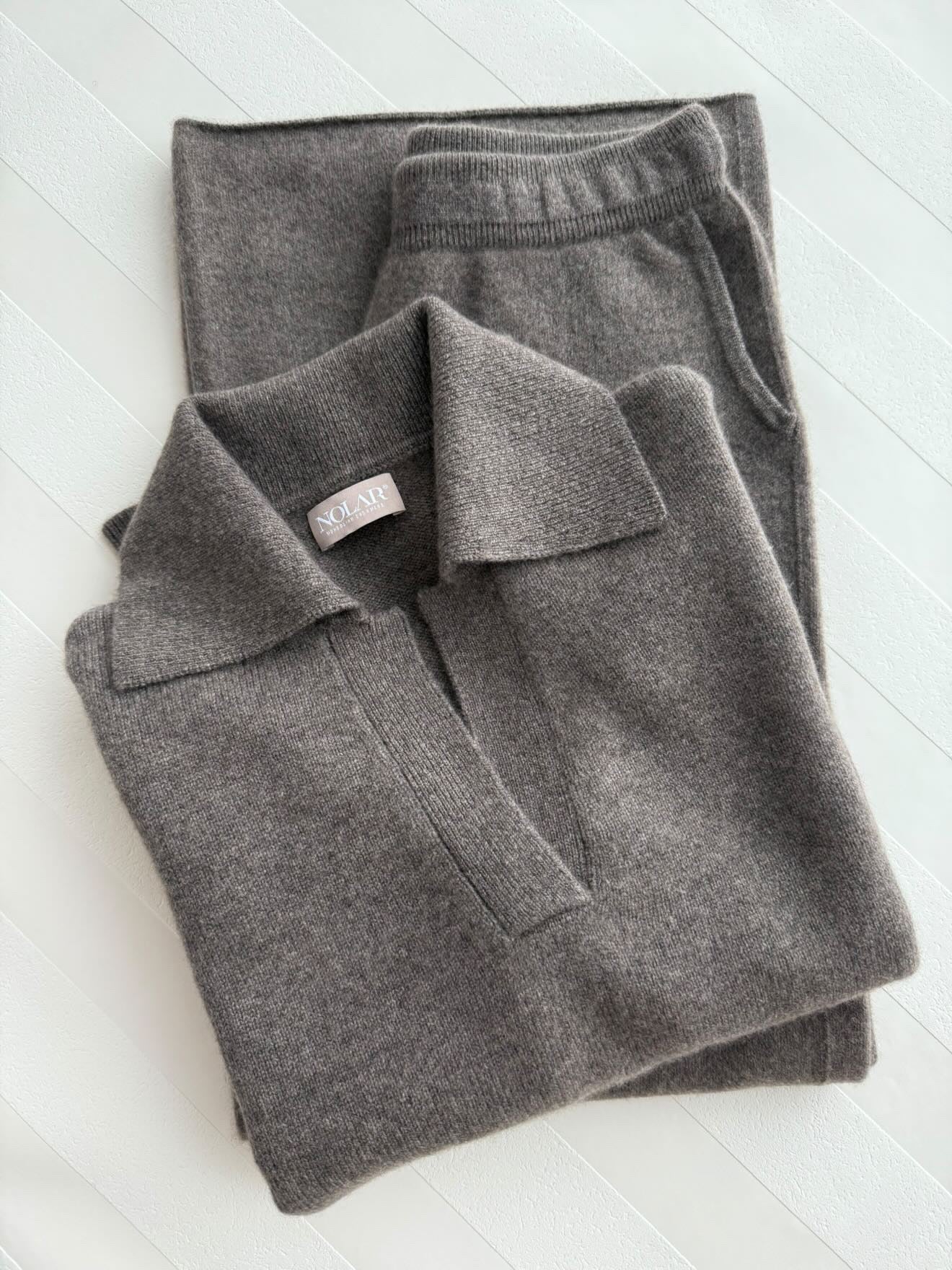 A folded brown cashmere polo paired with matching cropped pants.