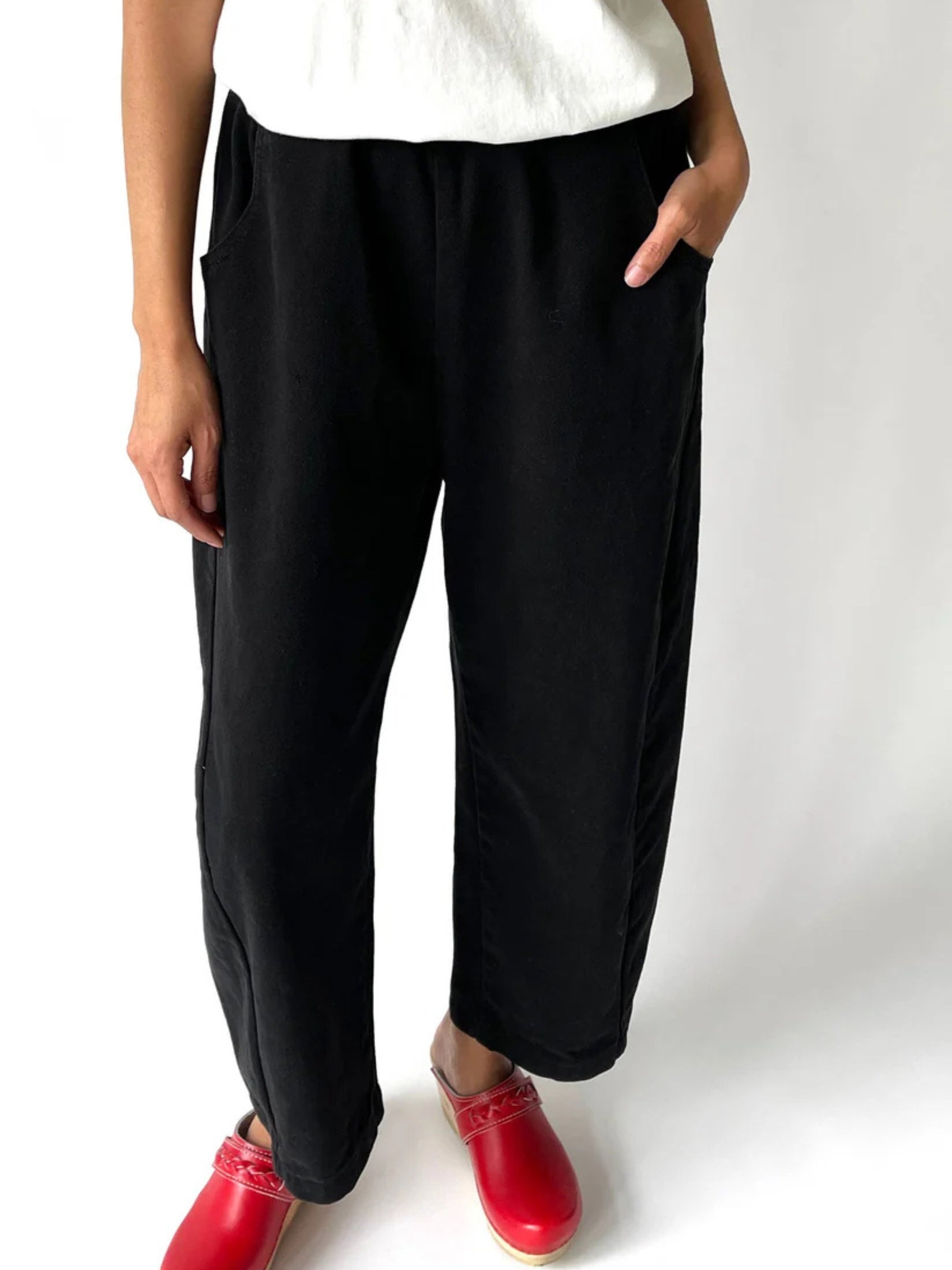 Model wearing black canvas arc pants with a relaxed, modern fit