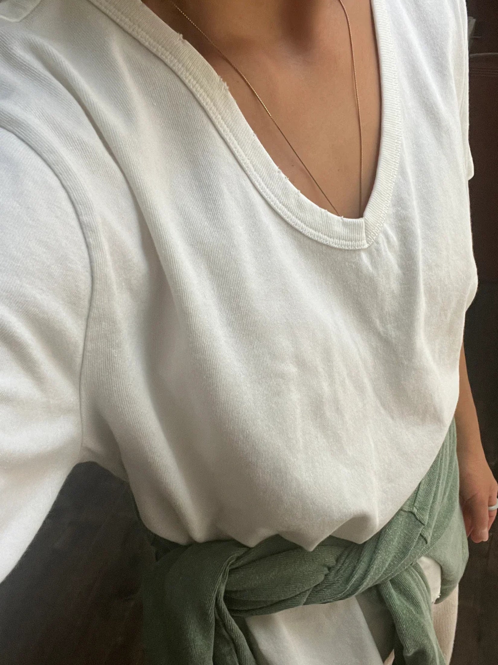Model wearing a white cotton La Vie V-neck tee with a relaxed fit.