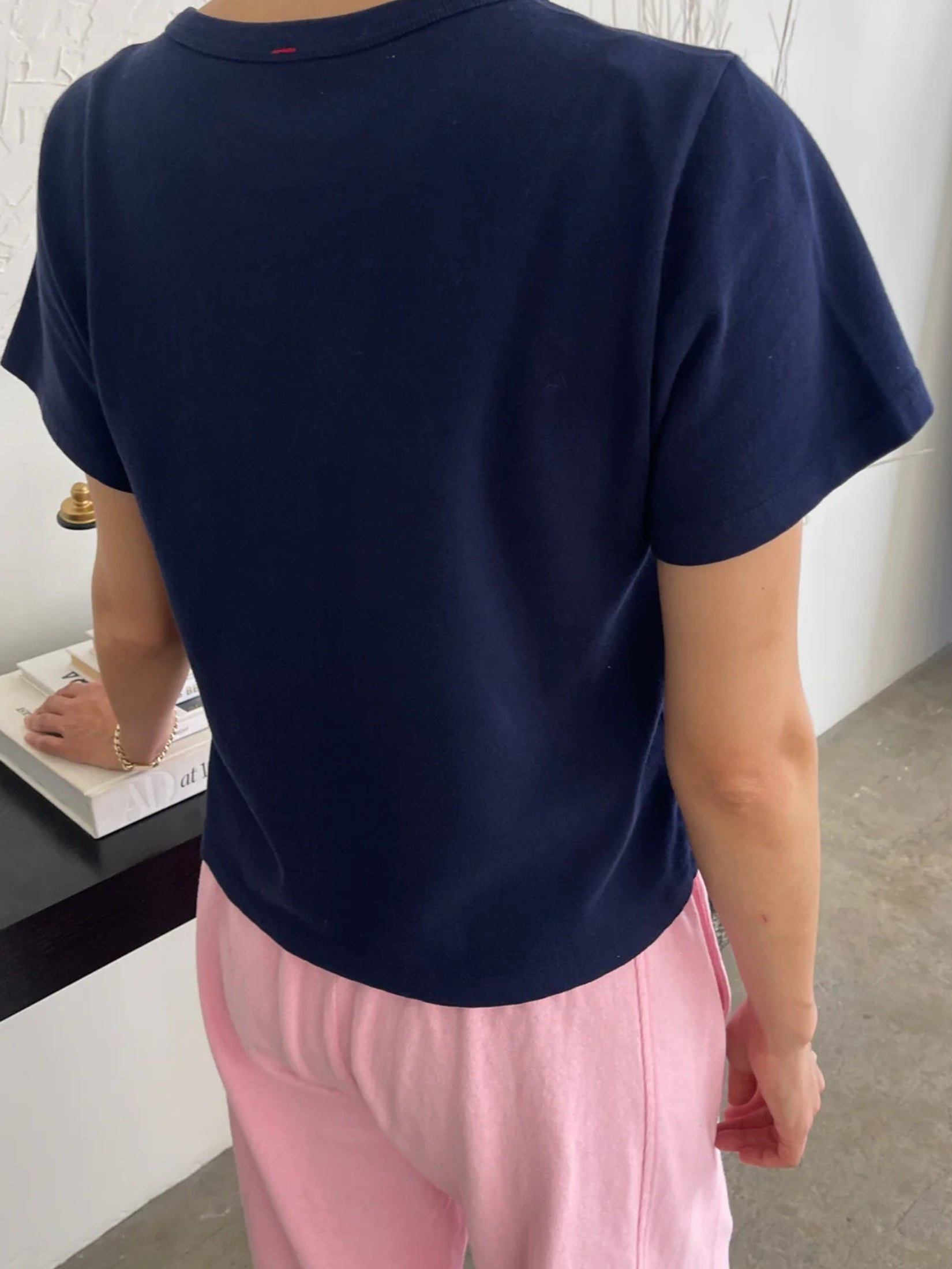 Model wearing a navy short cotton t-shirt with a relaxed fit.