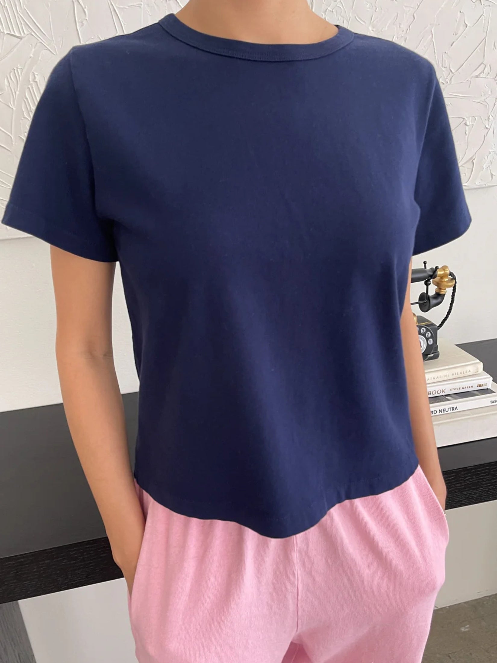 Model wearing a navy short cotton t-shirt with a relaxed fit.