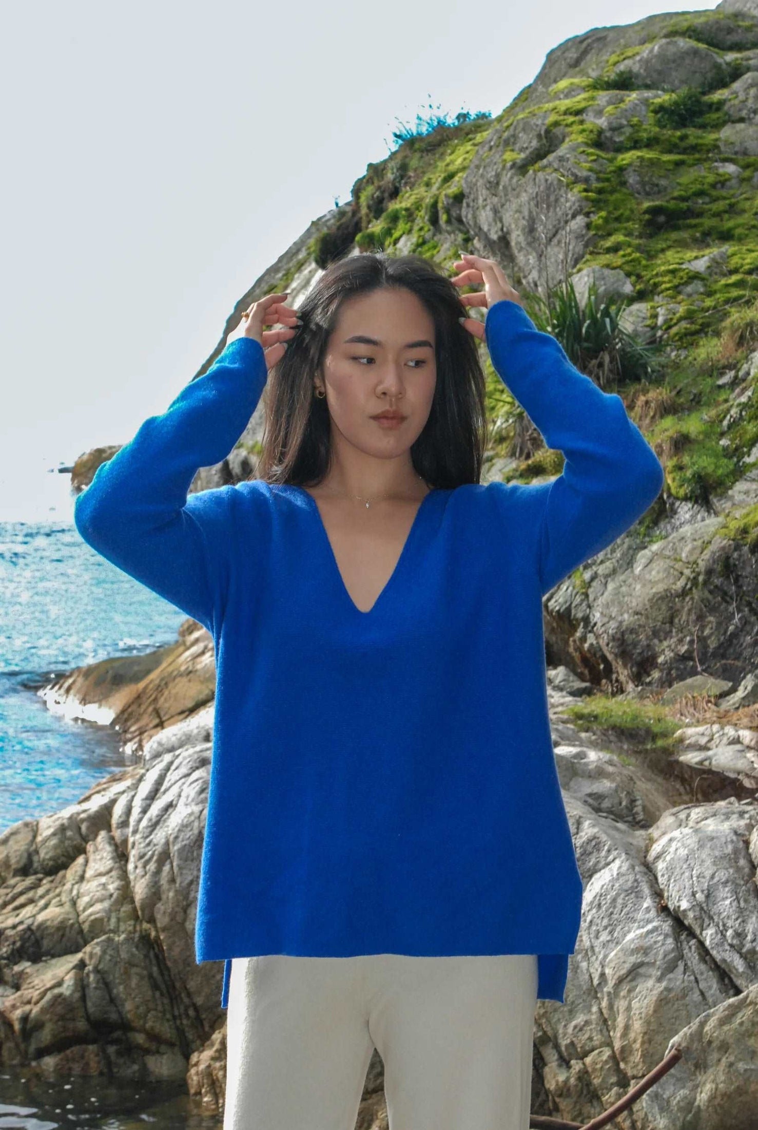 A model styled in a blue cashmere V neck sweater.