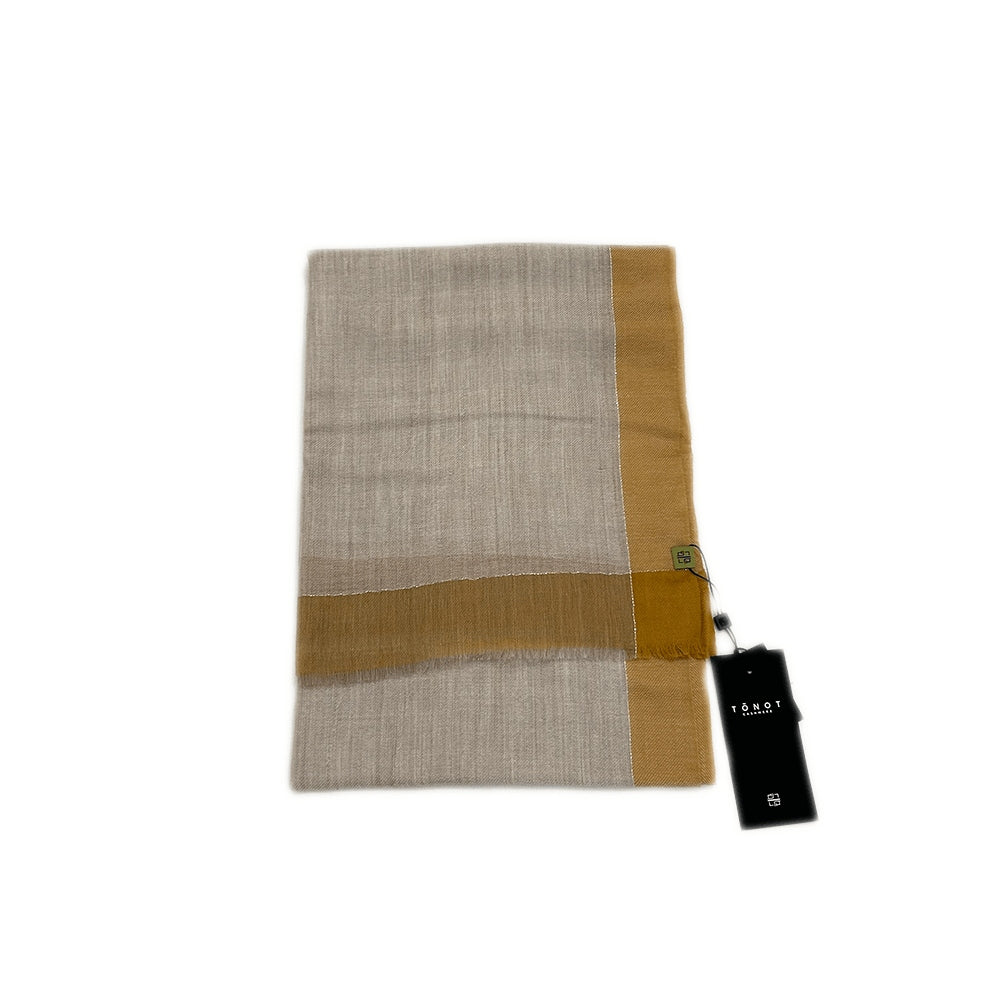 brown fine cashmere shawl, folded, showcasing its soft texture and elegant, refined look.