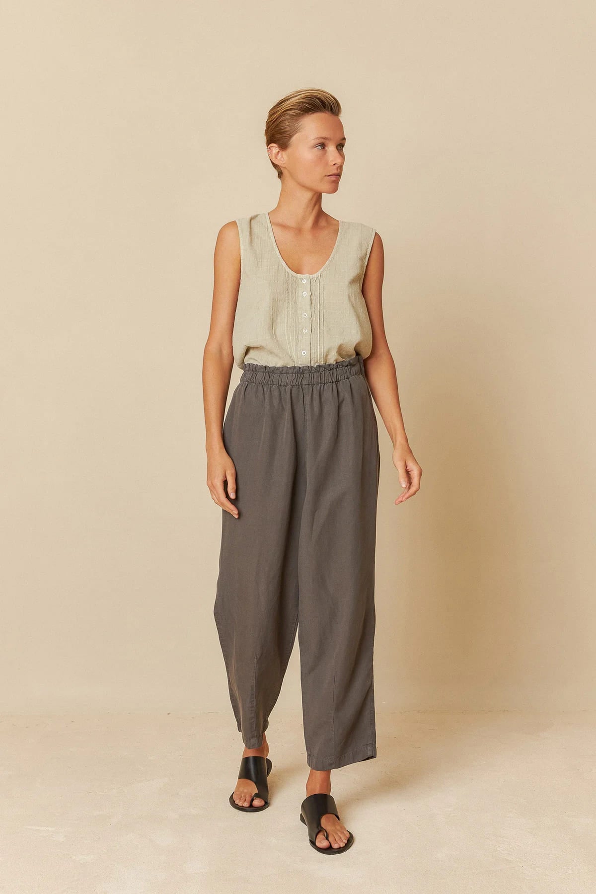 Model wearing charcoal lyocell linen pants with a relaxed fit.