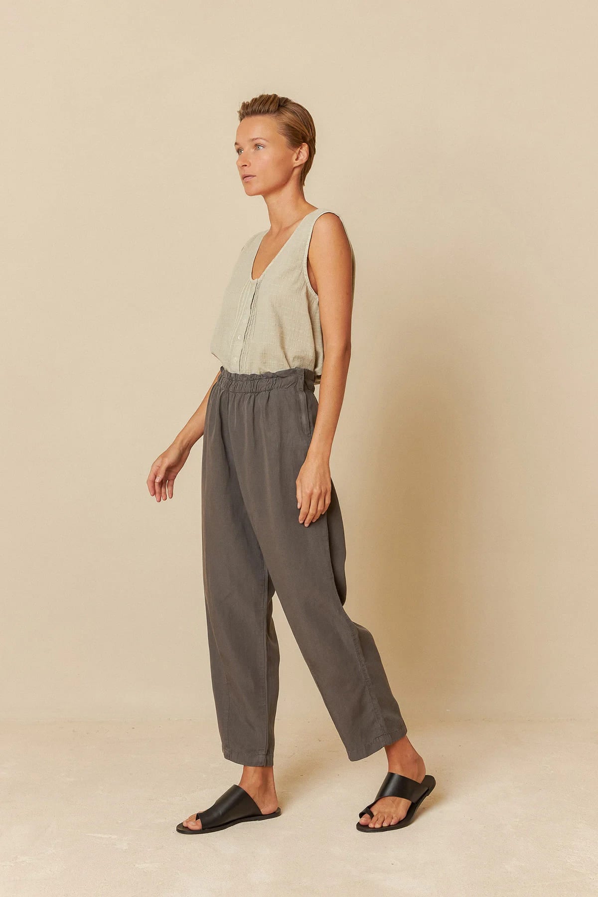 Model wearing charcoal lyocell linen pants with a relaxed fit.