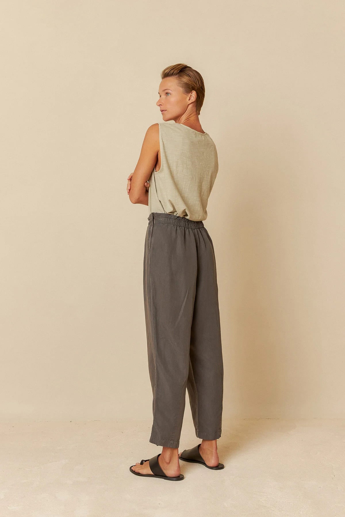 Model wearing charcoal lyocell linen pants with a relaxed fit.