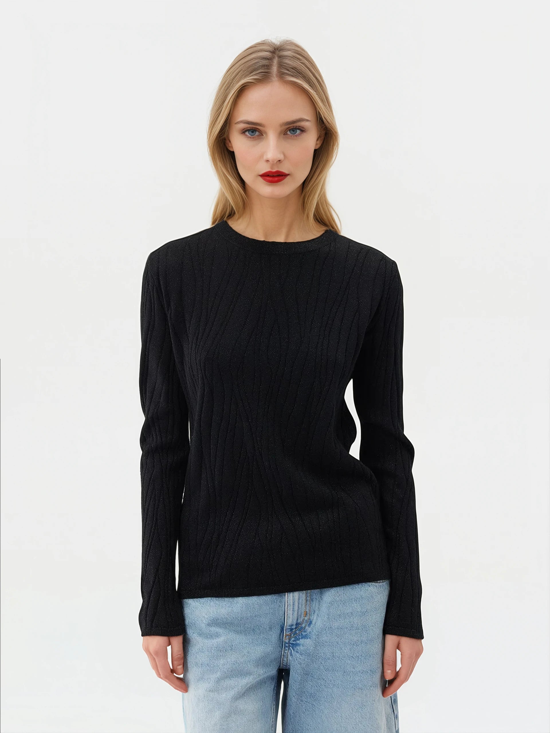 A model wearing a stylish black sweater made from a luxurious blend of silk, cashmere, with silver thread.