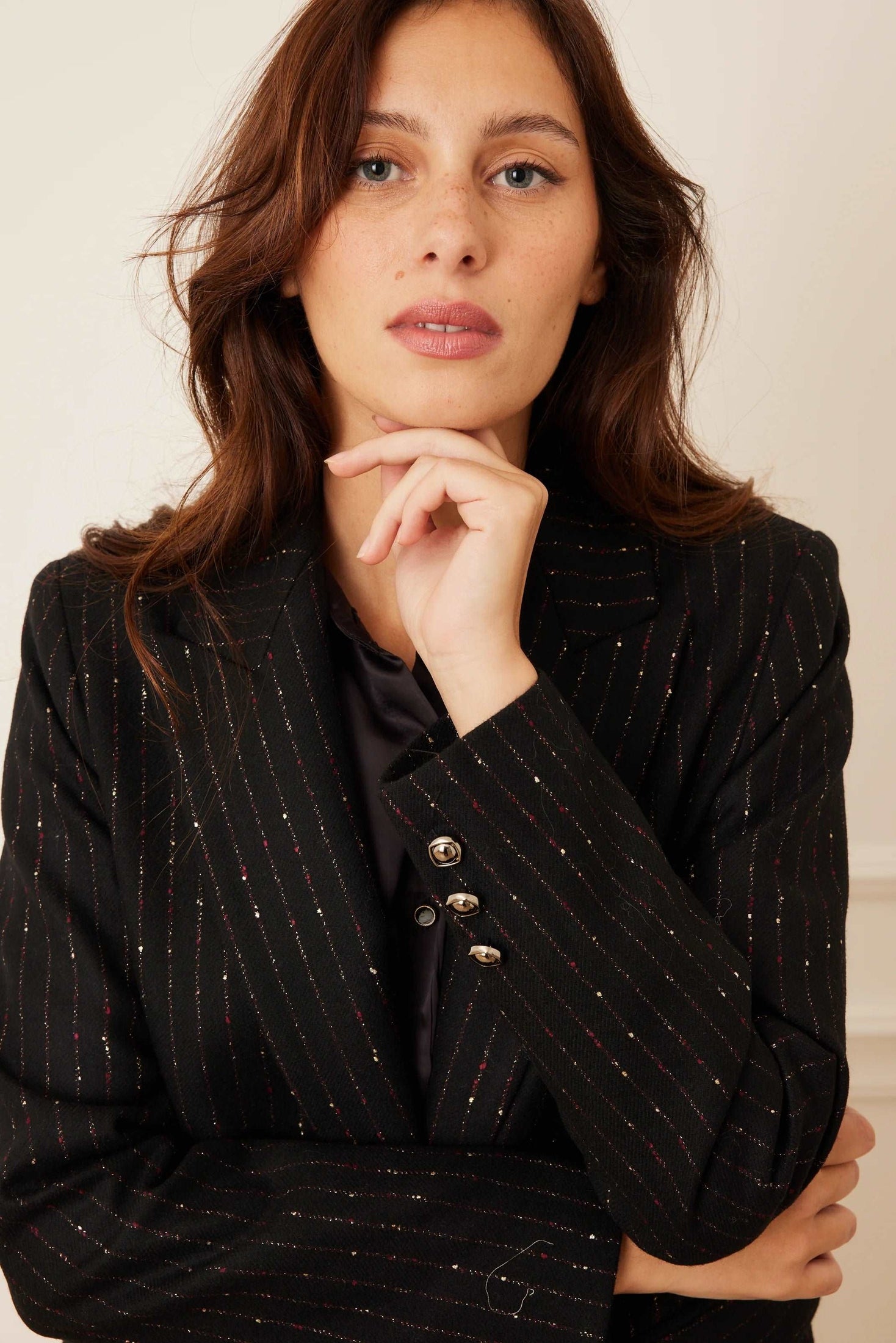 model wearing a black stripe wool blazer.