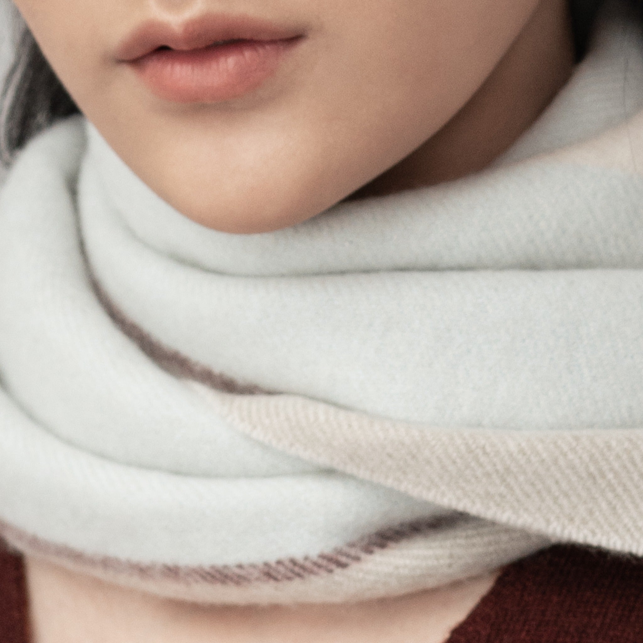 Soft cashmere scarf draped around the neck.