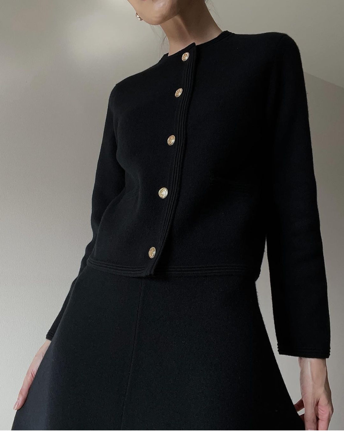 Black cashmere blazer set worn by model with skirt, featuring a tailored fit and elegant, sophisticated style.