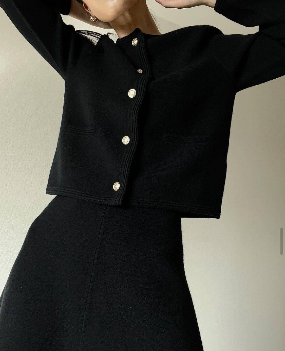 Black cashmere blazer set worn by model with skirt, featuring a tailored fit and elegant, sophisticated style.