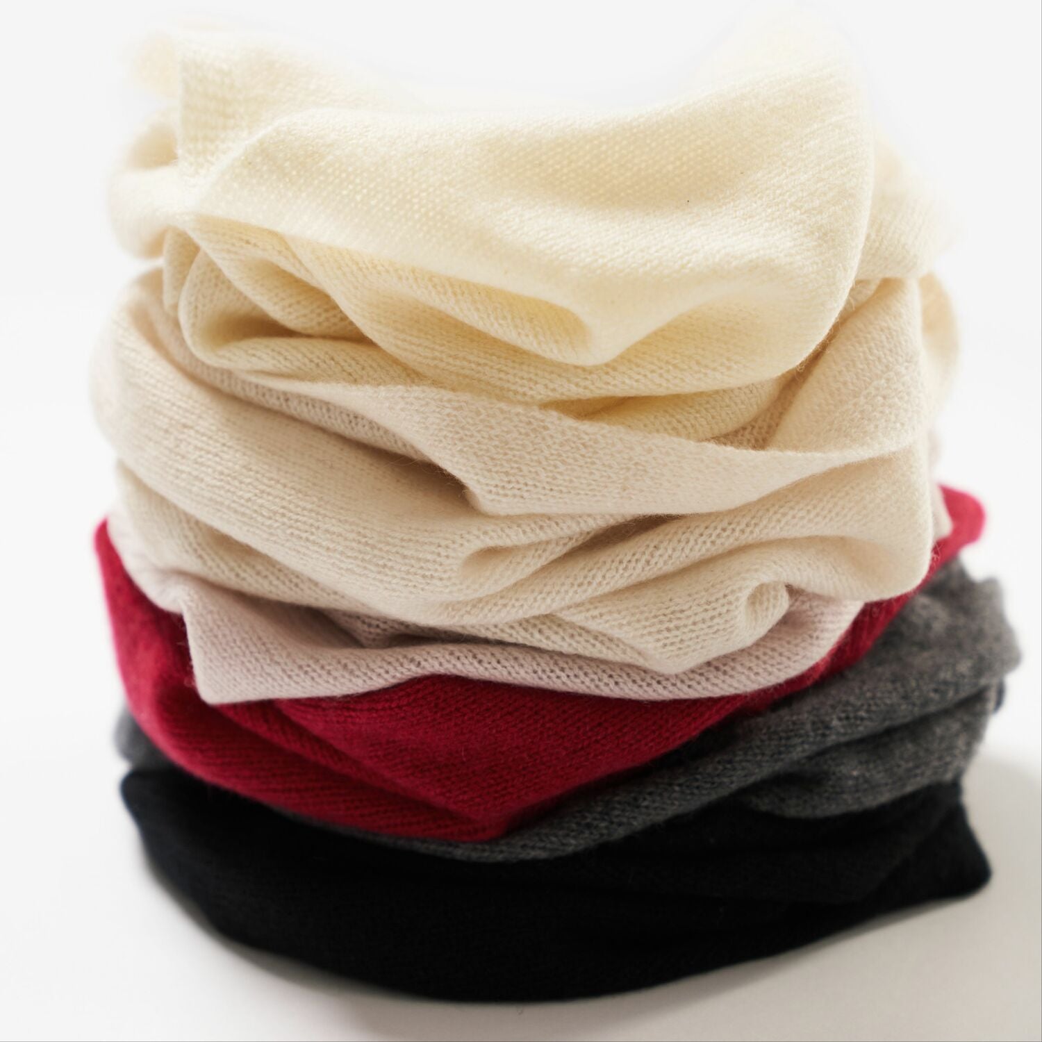 Cashmere tube scarfs piled.