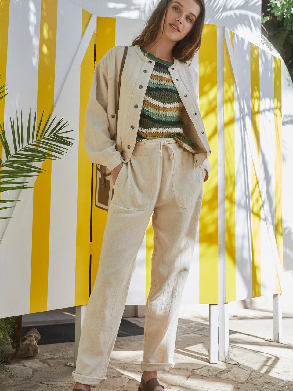 A model wearing an organic cotton set in ecru.