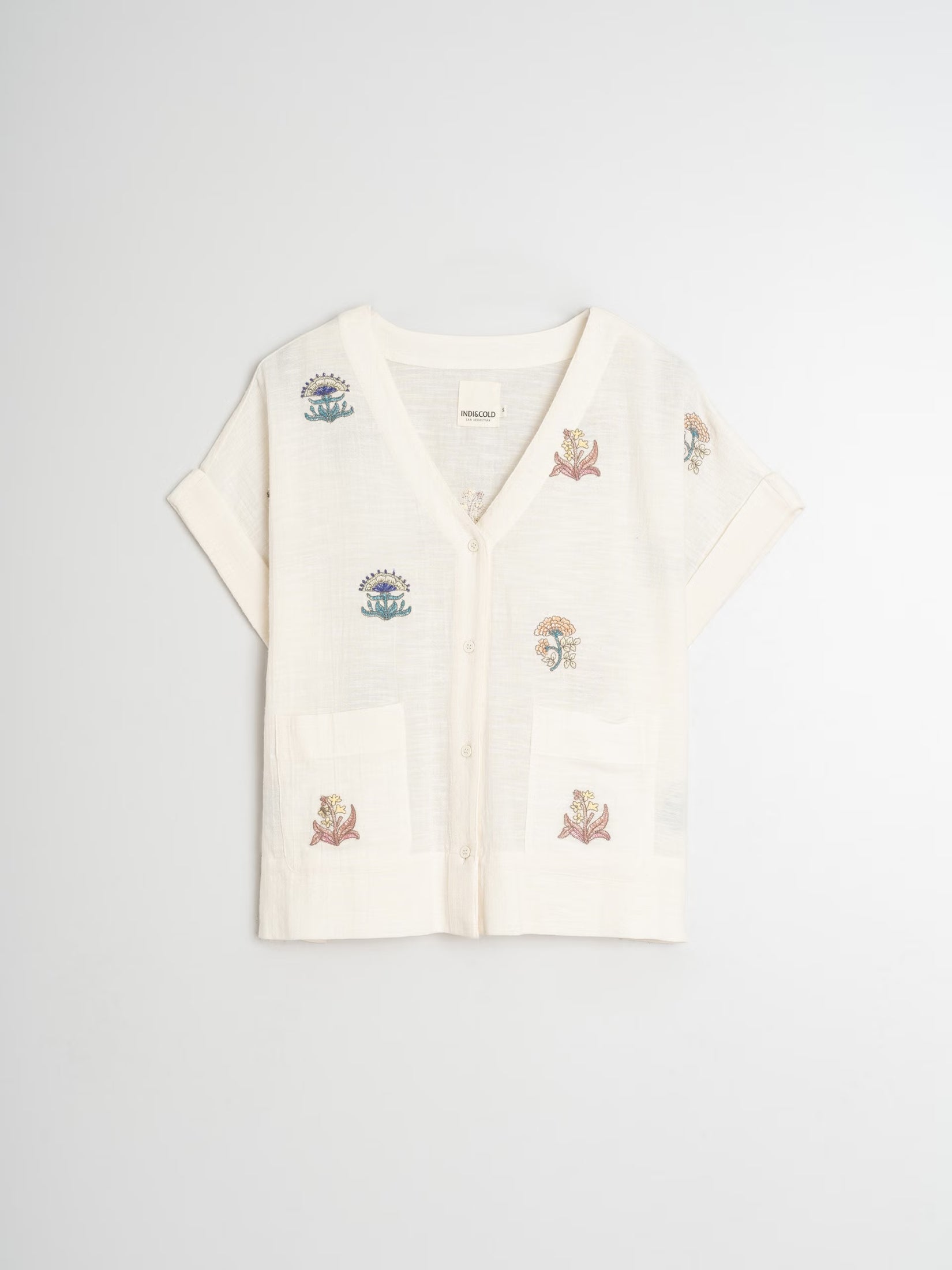 Flat lay of an ecru embroidered organic cotton shirt