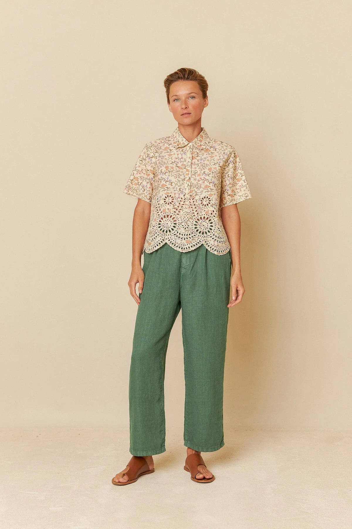 Model wearing a floral printed cotton shirt with delicate embroidery details.