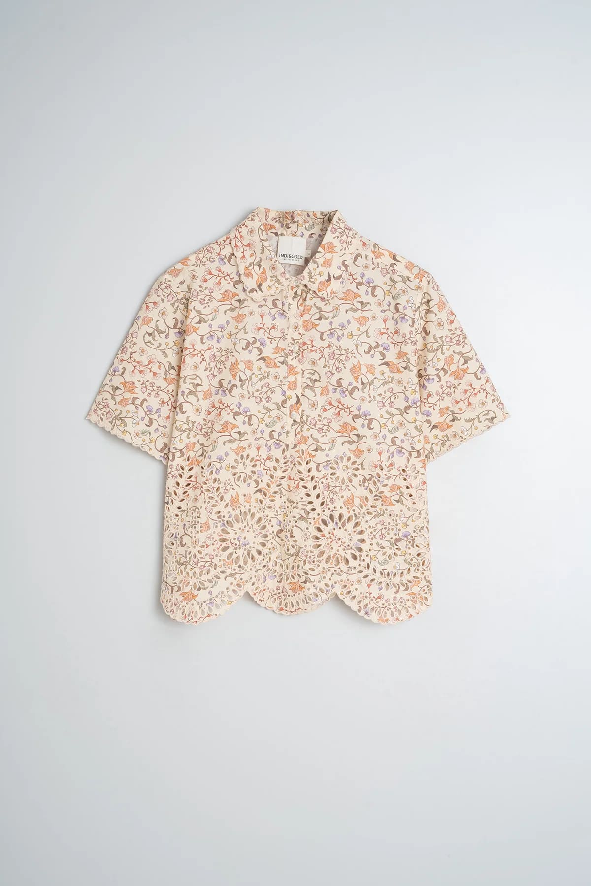 Flat lay of a floral printed cotton shirt with delicate embroidery details.