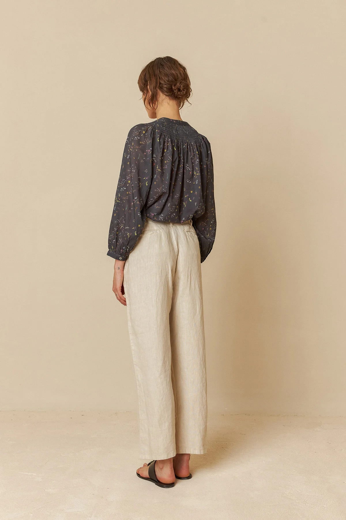 Model wearing relaxed-fit linen pants, showcasing a comfortable style.