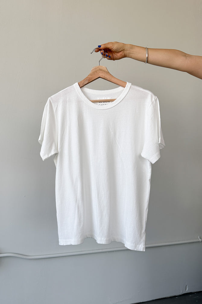 White cotton t-shirt on a hanger.