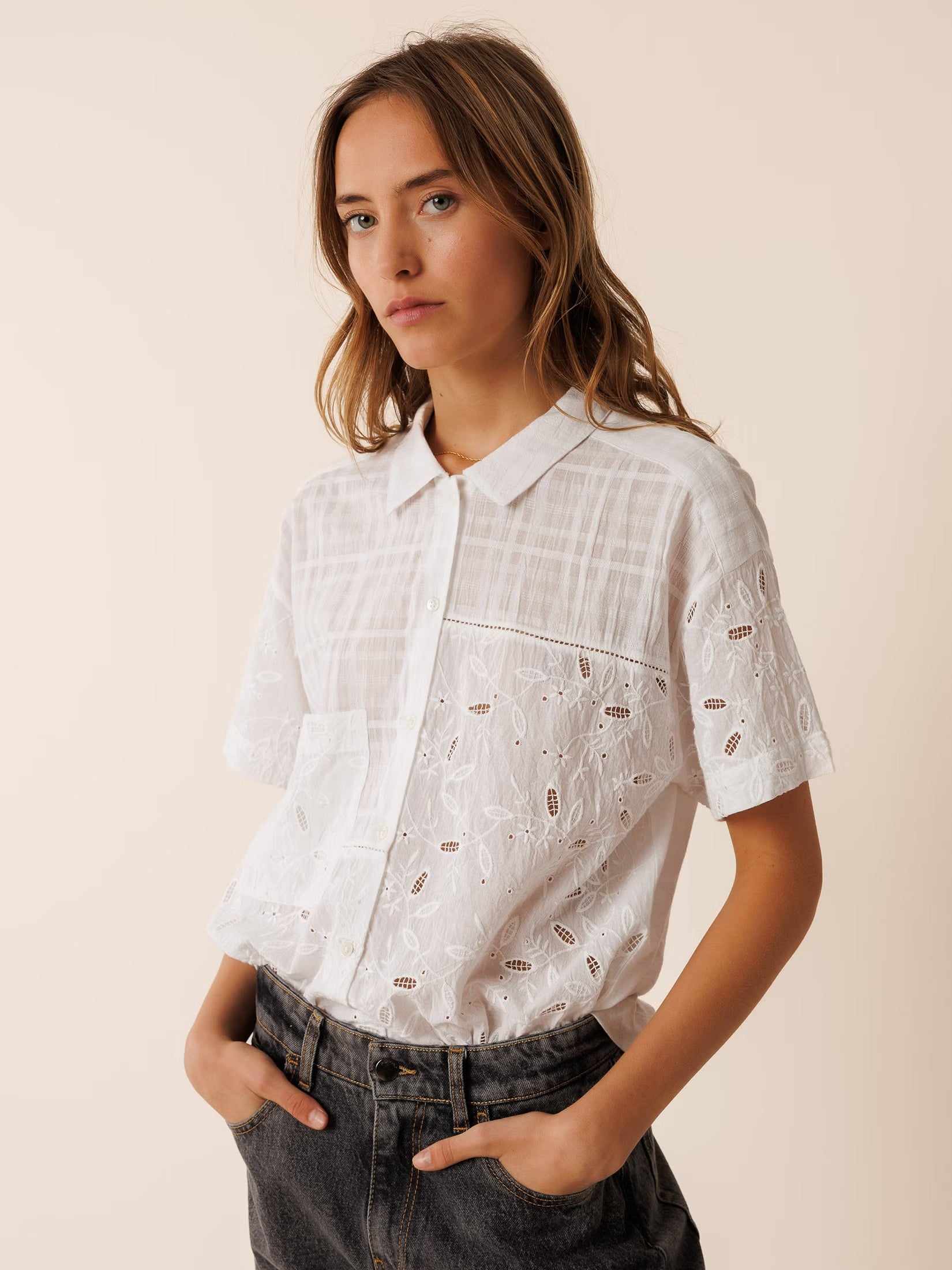 Model wearing an organic cotton shirt with combined embroidery details, adding a unique touch