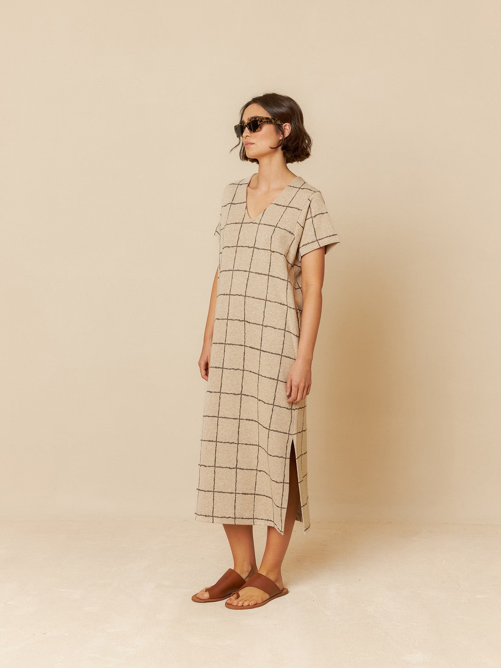 Model wearing a beige long dress with a relaxed fit, perfect for casual styling