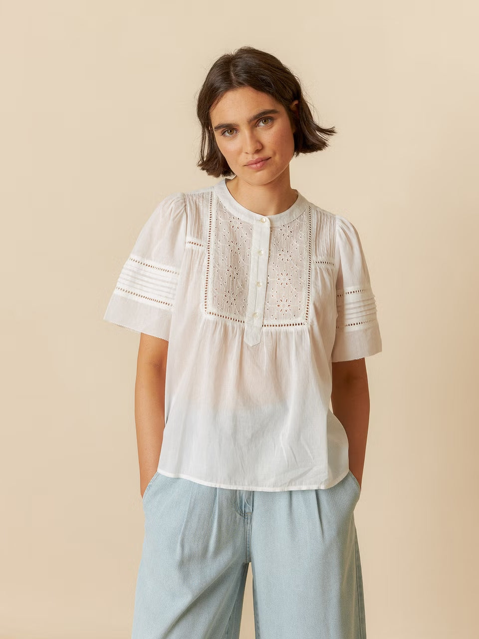 A model wearing a short-sleeve cotton shirt, featuring a relaxed fit and breathable fabric.