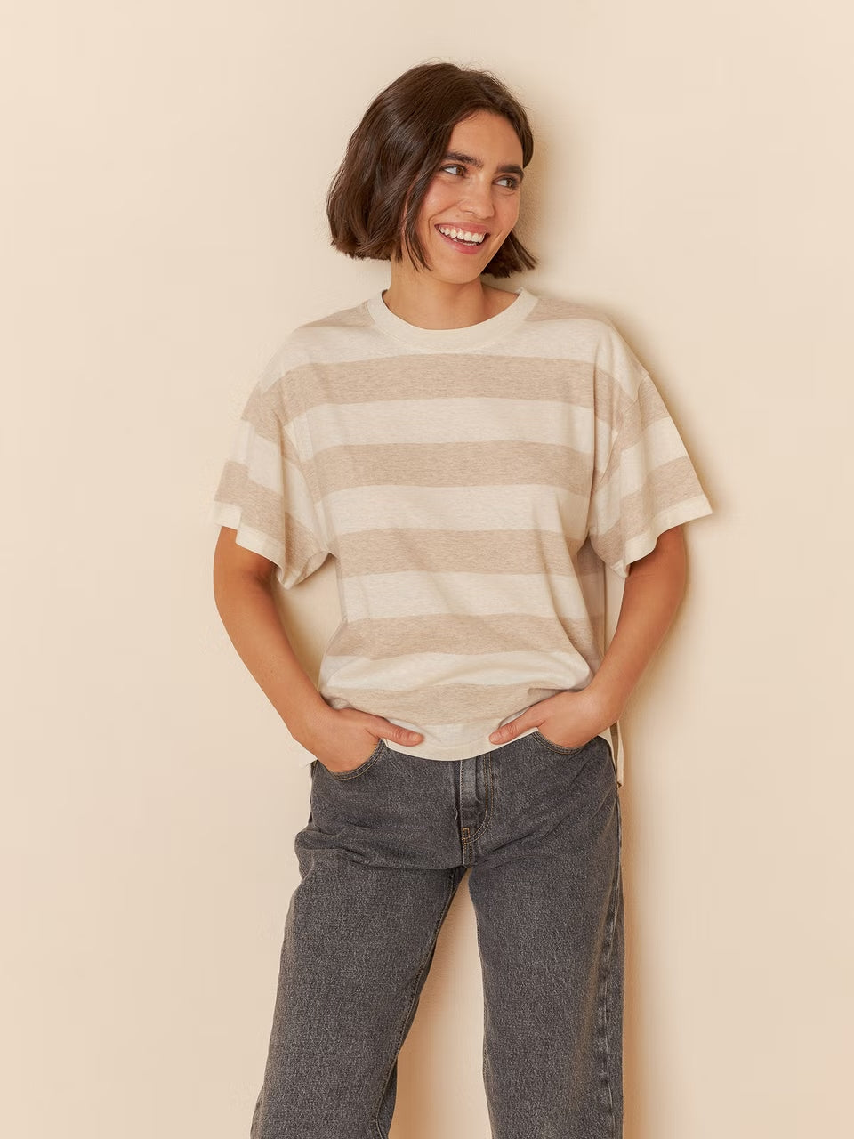 A model wearing a short-sleeve striped t-shirt with a relaxed fit and classic stripes.