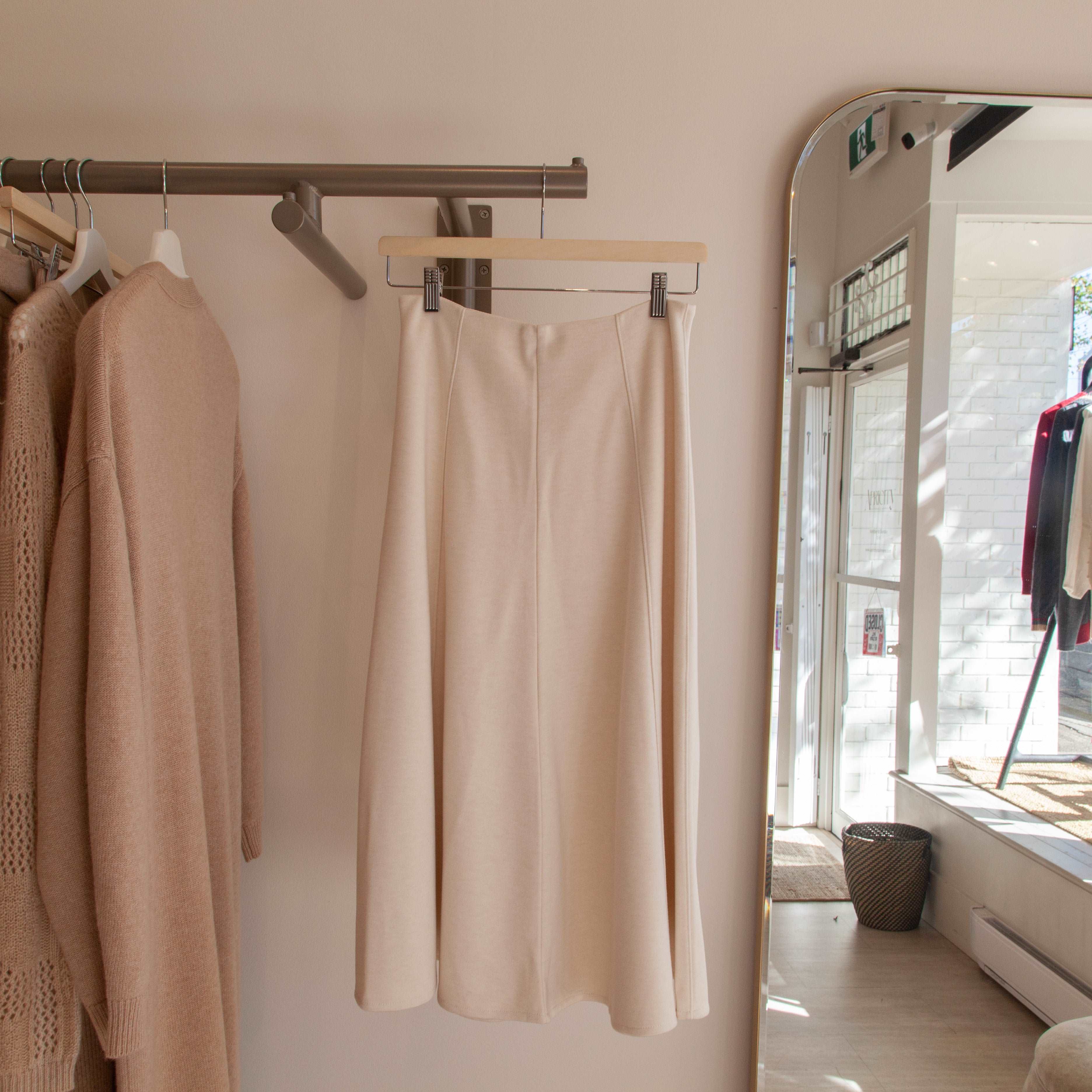 Cream-colored medium-long wool skirt.